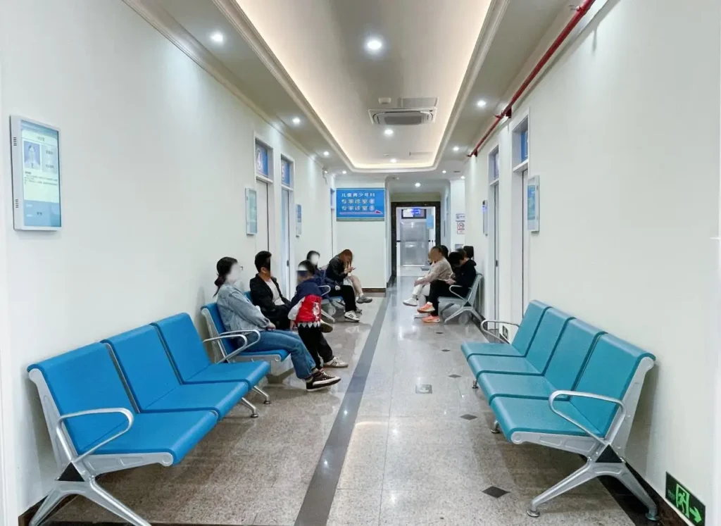 Hospital waiting area with blue seating in Shenzhen